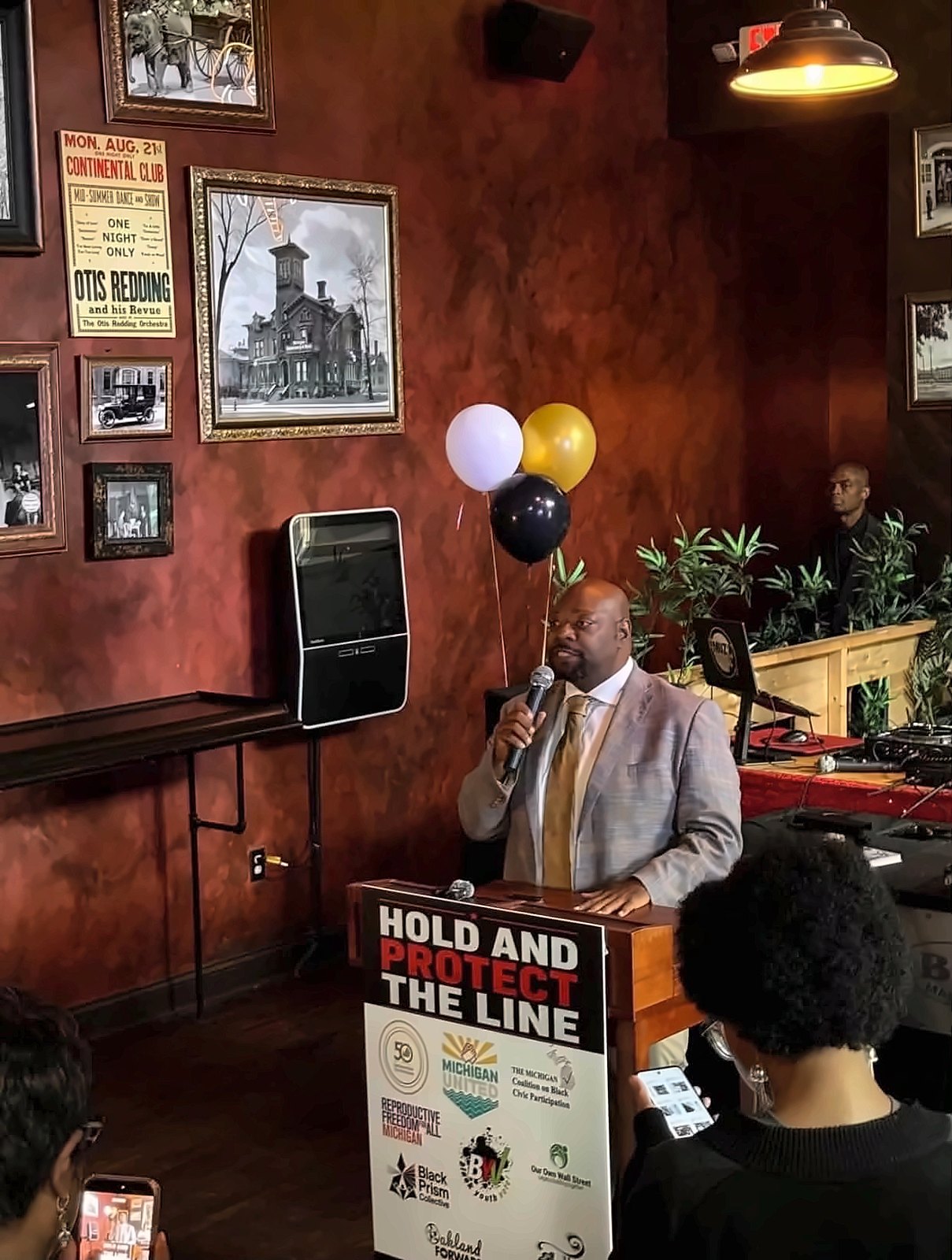Kermit Williams speaking with a microphone at a Hold and Protect the Line event